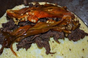 Chilpotle Caribou Flake in an omelet with roasted peppers on top before folding