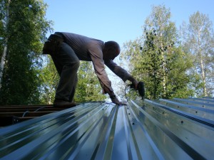 Screwing down the steel roof
