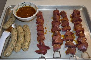 Sausages and caribou heart anticuchos headed for the grill.